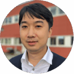 Portrait of a man standing in front of a red building